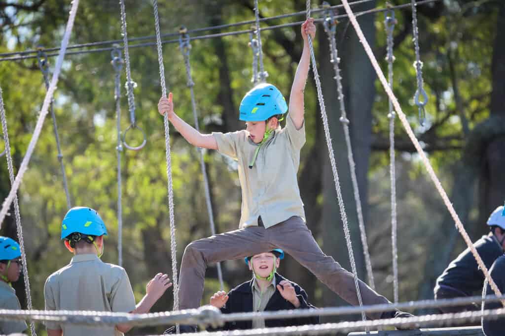 Tudor House student doing the high ropes course