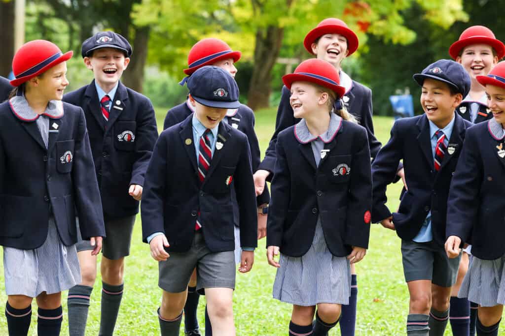 Tudor House student leaders walking in a line and smiling