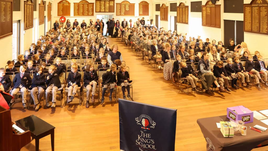 Tudor House students sitting on chairs in the school hall