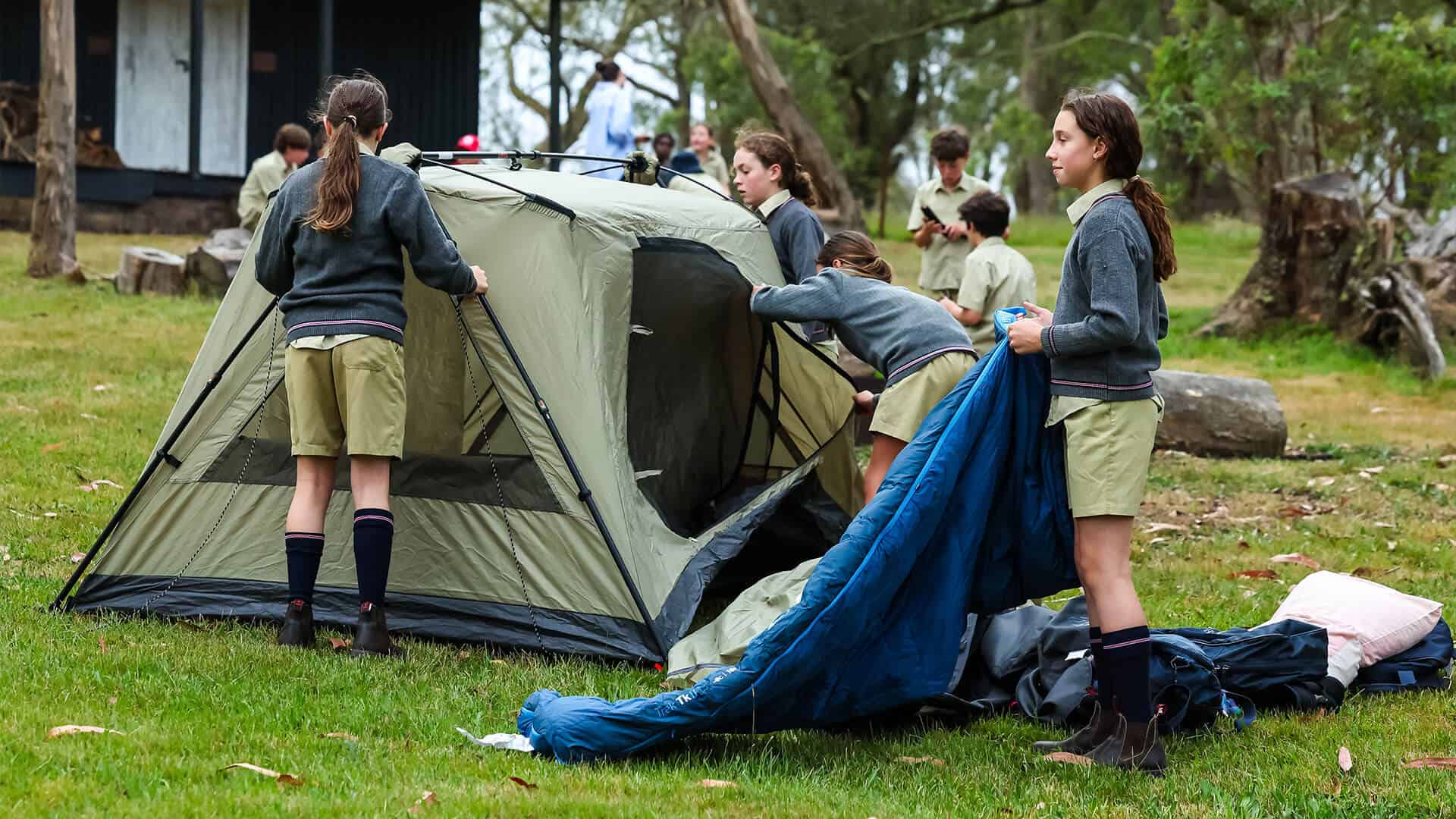 Tudor House students setting up a tent for a camp out