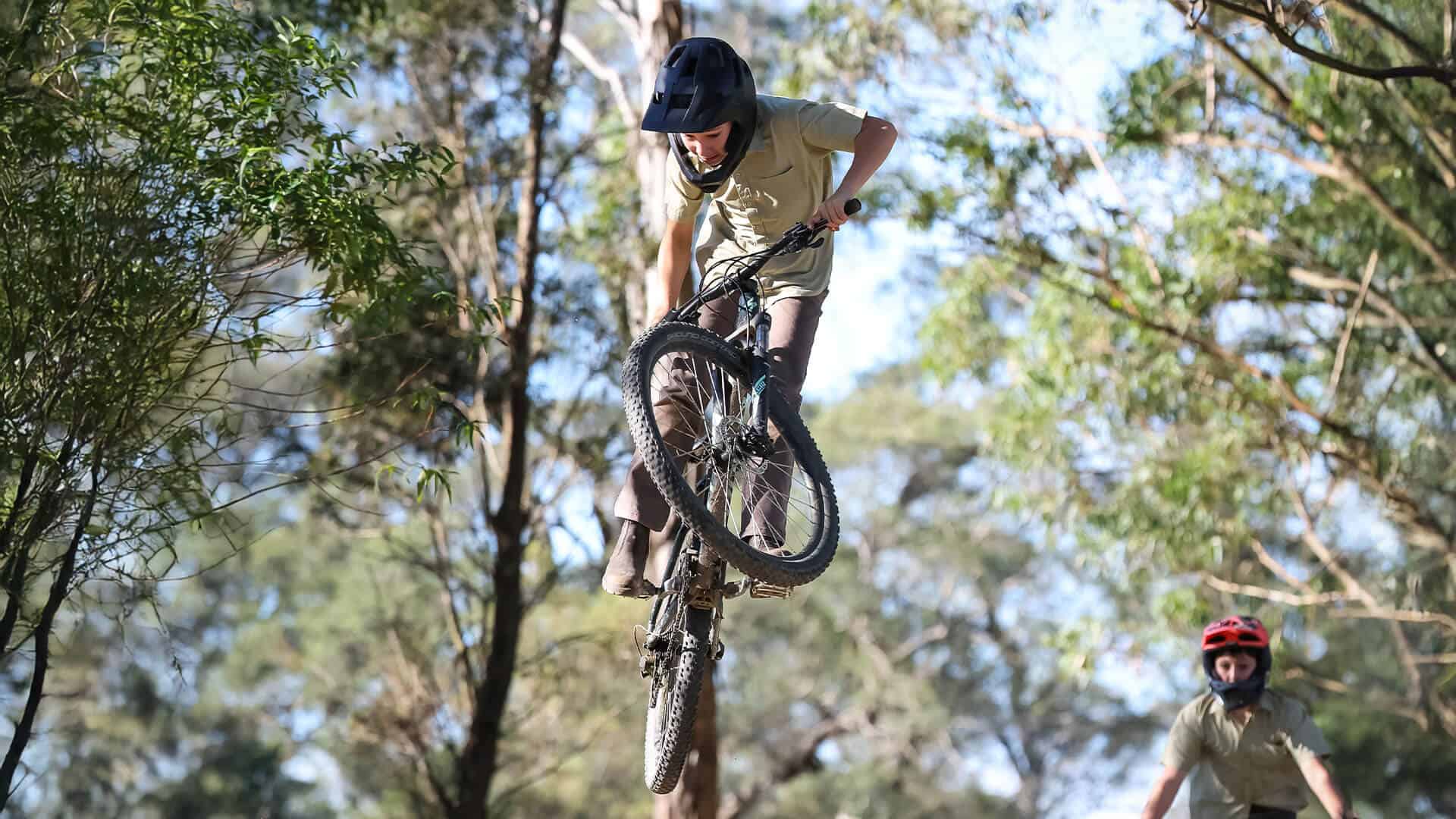Tudor House student riding his bike over a large jump mid air