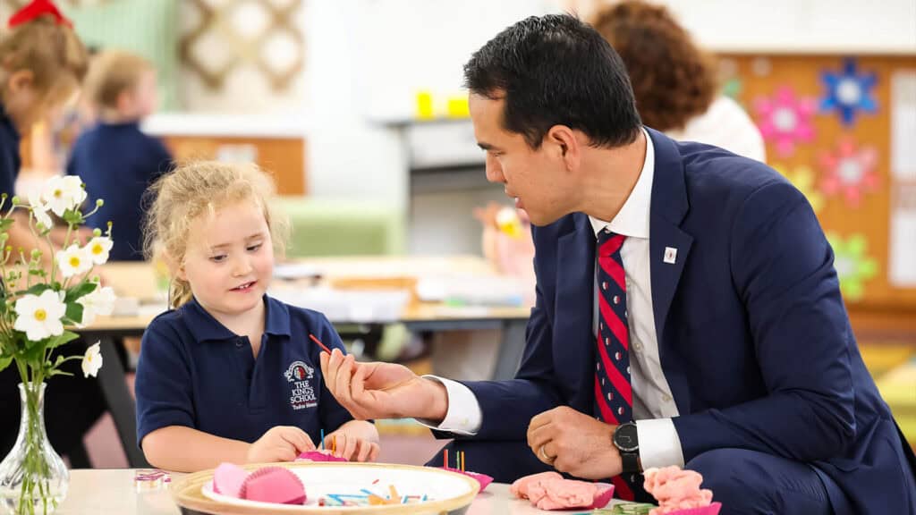 Head of Tudor House in a classroom interacting with a Tudor House pre-kindergarten student