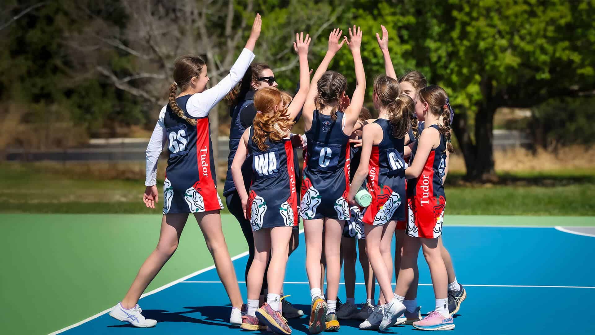 Tudor House students playing netball as a team