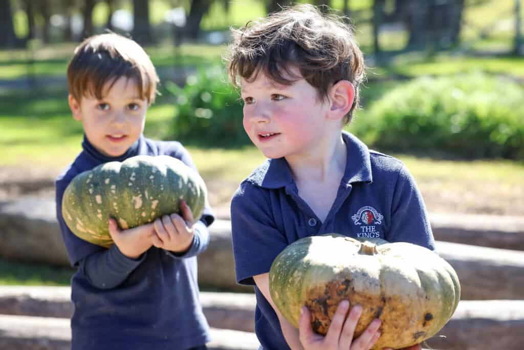 Tudor House pre-kindergarten students holding pumpkins