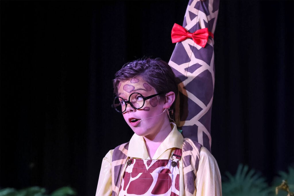 Tudor House student in costume on stage for a musical theatre performance