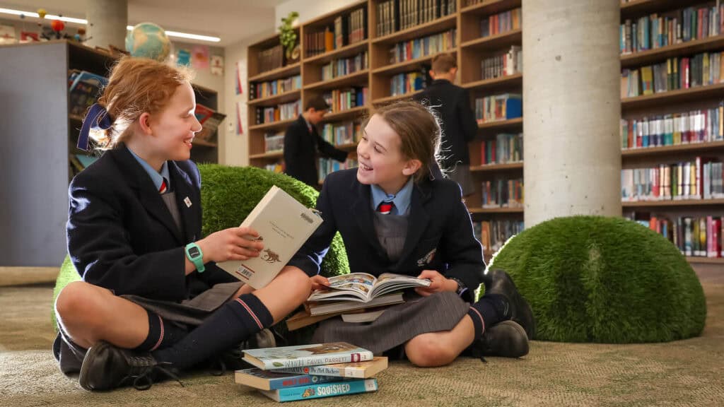 Tudor House students sitting in the library reading books