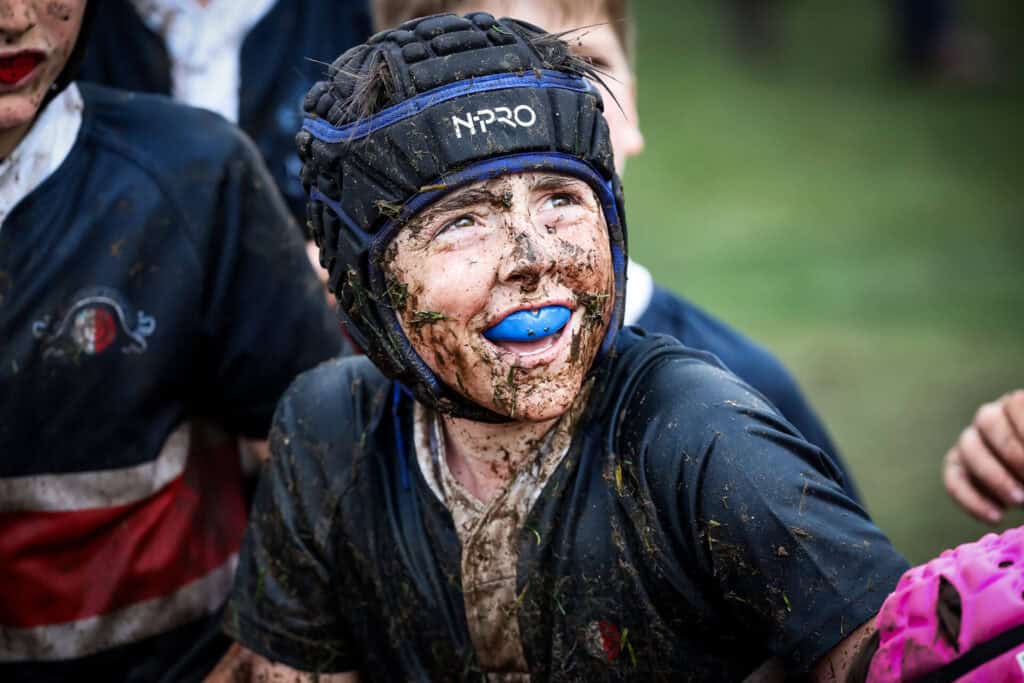 Tudor House Students Playing Rugby in the Mud