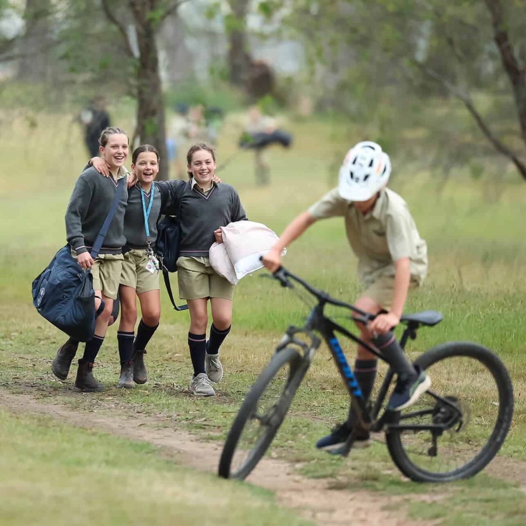 Tudor House students camping out at Kahiba laughing and riding bikes